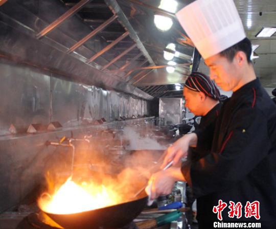 7日下午,保定会馆秀兰店烹任大师康彦库正在为顾客准备年夜饭。 于俊亮 摄 7日下午,保定会馆秀兰店烹任大师康彦库正在为顾客准备年夜饭。 于俊亮 摄