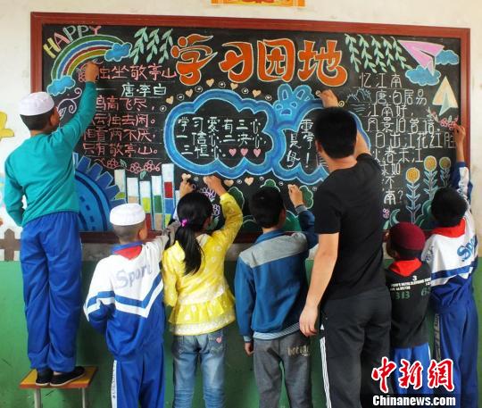 图为于瑞和学生们一起办黑板报。 郭红 摄 图为于瑞和学生们一起办黑板报。 郭红 摄